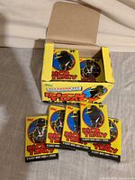 Open display box with several sealed packs shown