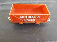Left side view showing McColl's Farm lettering and wheels