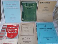 All six piano sheet music booklets laid flat