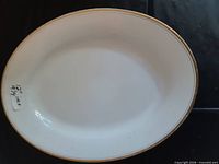 Top view of oval platter showing gold rim and white surface