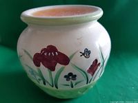 Front view showing floral decoration and top wax-filled dish