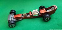 Side view of dragster showing body, wheels and engine