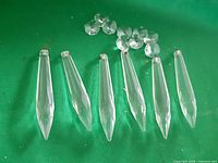 Six spike prisms and seven octagonal prisms laid out on green background