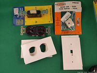 Group shot with all foam pads, receptacle, Leviton plug, packaged switch