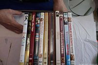 Spine view of 11 DVD cases showing most titles