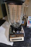 Full view of Osterizer blender with glass jug and base