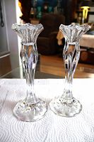 Front view of both crystal candlestick holders standing side by side
