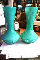 Full view of both matching frosted seafoam green glass vases