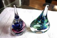 Both glass sculptures side by side on white surface