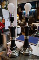 Two matching table lamps on surface with bulbs inserted