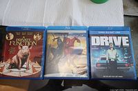 Front view of all three Blu-ray cases: A Private Function, Spider-Man 3, Drive