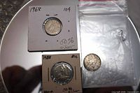 All three dimes together: two in cardboard holders labeled 1968 50% silver and one loose 1961 dime
