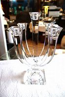 full front view of clear crystal five-arm candelabra on white cloth
