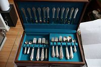 Open flatware chest showing full service pieces in place