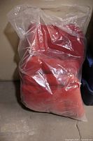 Bag containing several red cushions