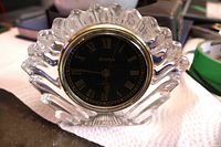 Front view of Bulova desk clock showing crystal case and black dial