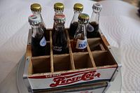 Top view of crate with 6 of 7 filled bottles showing labels and dividers
