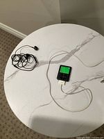 iPod, cable, and earbuds displayed on tabletop