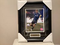 Full view of framed Beckham photo with corner guards