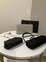 All four purses displayed together on table