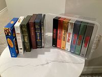 All 13 DVD box sets arranged: Seinfeld, Lord of the Rings, Indiana Jones, Sopranos inside clear bin