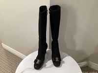 Full frontal view of both knee-high boots standing upright