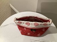 Top view showing red and white paisley quilted bread bag standing open