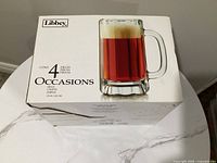 Retail box showing Libbey branding, 4-piece Occasions beer mugs, 16 oz
