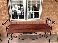 Full view of metal bench beneath window