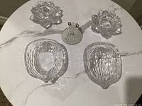 Group view: two glass candle holders, two glass bowls, one glass figurine