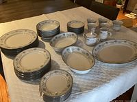 Full set laid out showing plates, bowls, cups, sugar, creamer, platter