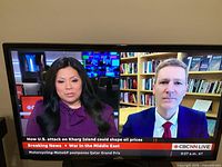 Front view showing news broadcast on screen