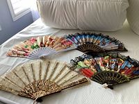 All four folding hand fans laid out to show design and size