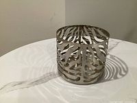Angled view of the zebra-pattern metal votive holder