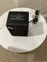 Front and top view showing controls, mesh grille, power cord