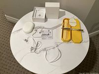 Entire lot laid out showing pen set and earbuds set