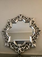 Front view of ornate silver quatrefoil wall mirror