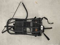 Full view of black aluminum frame backpack showing frame, straps, waist belt and support bar