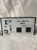 Front view showing brand, model, rating, outlets, switches and fuse