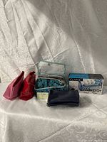 Group shot of all bags, Clairol box, navy pouch