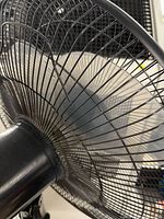 Close-up rear view of fan head and wire grill