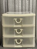 Front view showing three drawers and handles