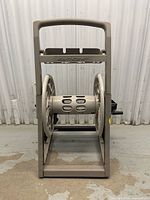 Front view of Suncast hose reel cart showing drum, frame, and branding