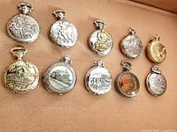 Ten closed pocket watches showing embossed case designs