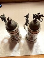 Top view of both steins showing pewter lids and finials