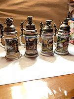 Front view of all four German regimental lithophane beer steins