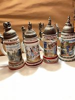 Front view of four regimental steins side by side