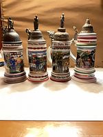 Front view of four German regimental steins