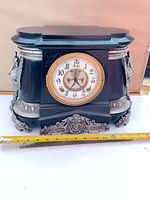 Front view showing entire clock, dial, and base ornament