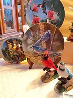 Group view showing hummingbird plate, blue jay plate, red and blue bird figurines